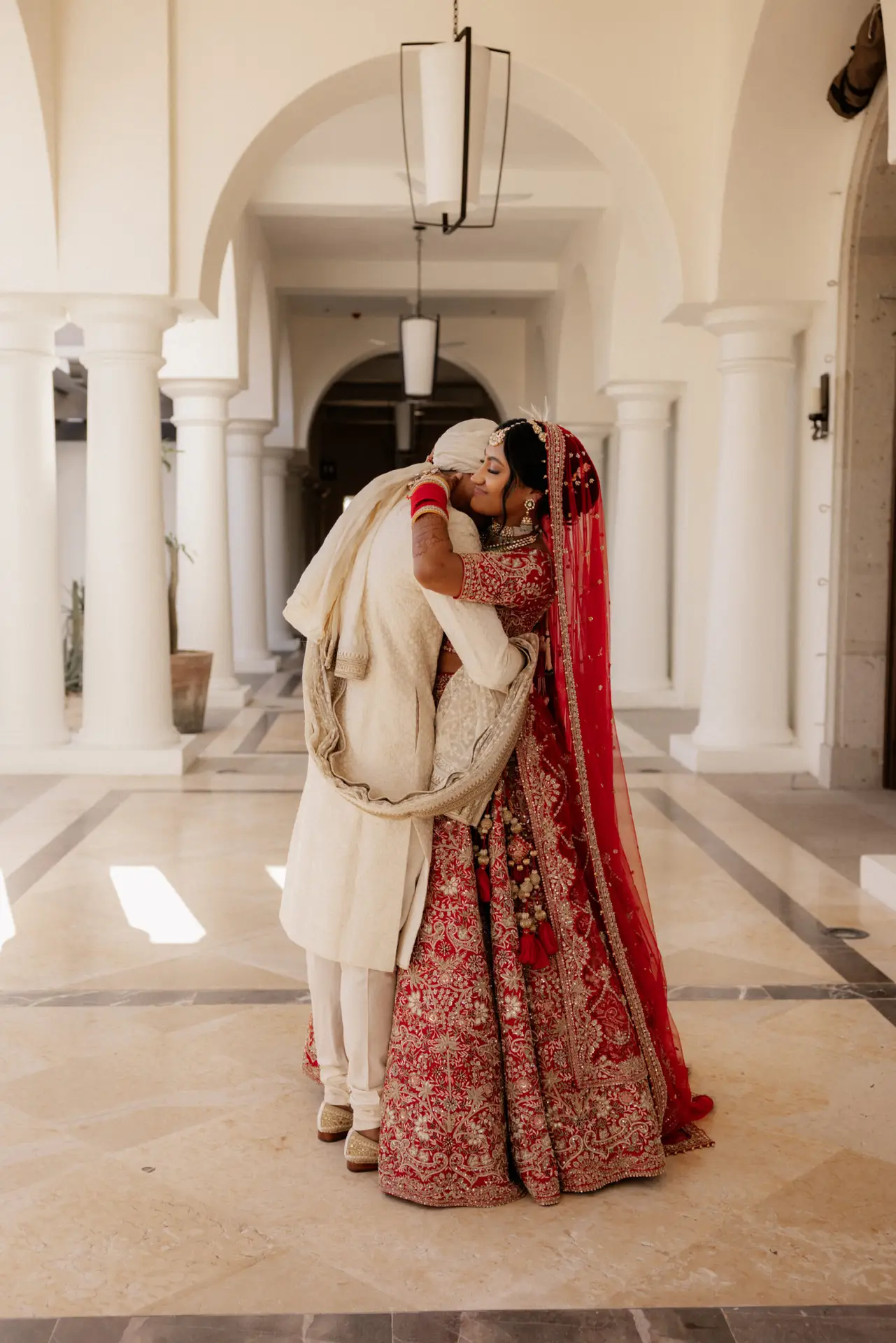 Couple embracing in traditional attire. photo taken by Ximena Zermeño Global Luxury Destination Wedding Photographer, ximenazermeno.com