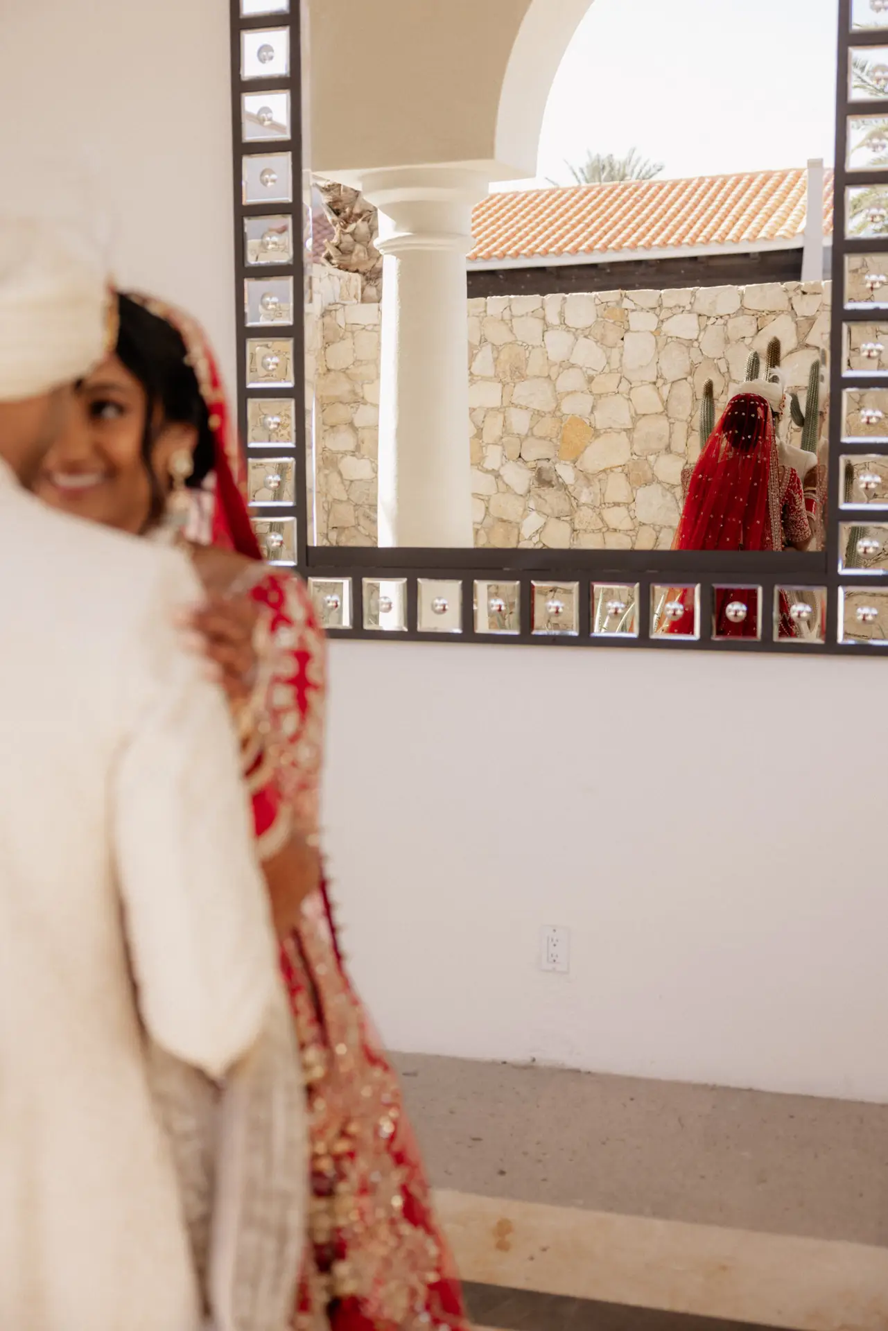 Bride in red dress near mirror. photo taken by Ximena Zermeño Global Luxury Destination Wedding Photographer, ximenazermeno.com