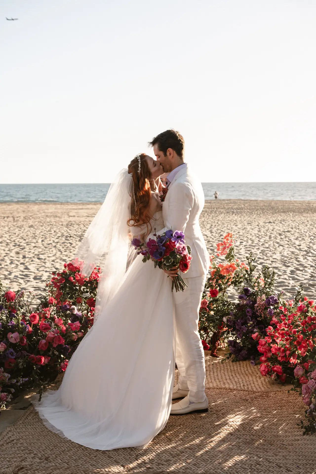 Couple embracing on a beach wedding. photo taken by Ximena Zermeño Global Luxury Destination Wedding Photographer, ximenazermeno.com