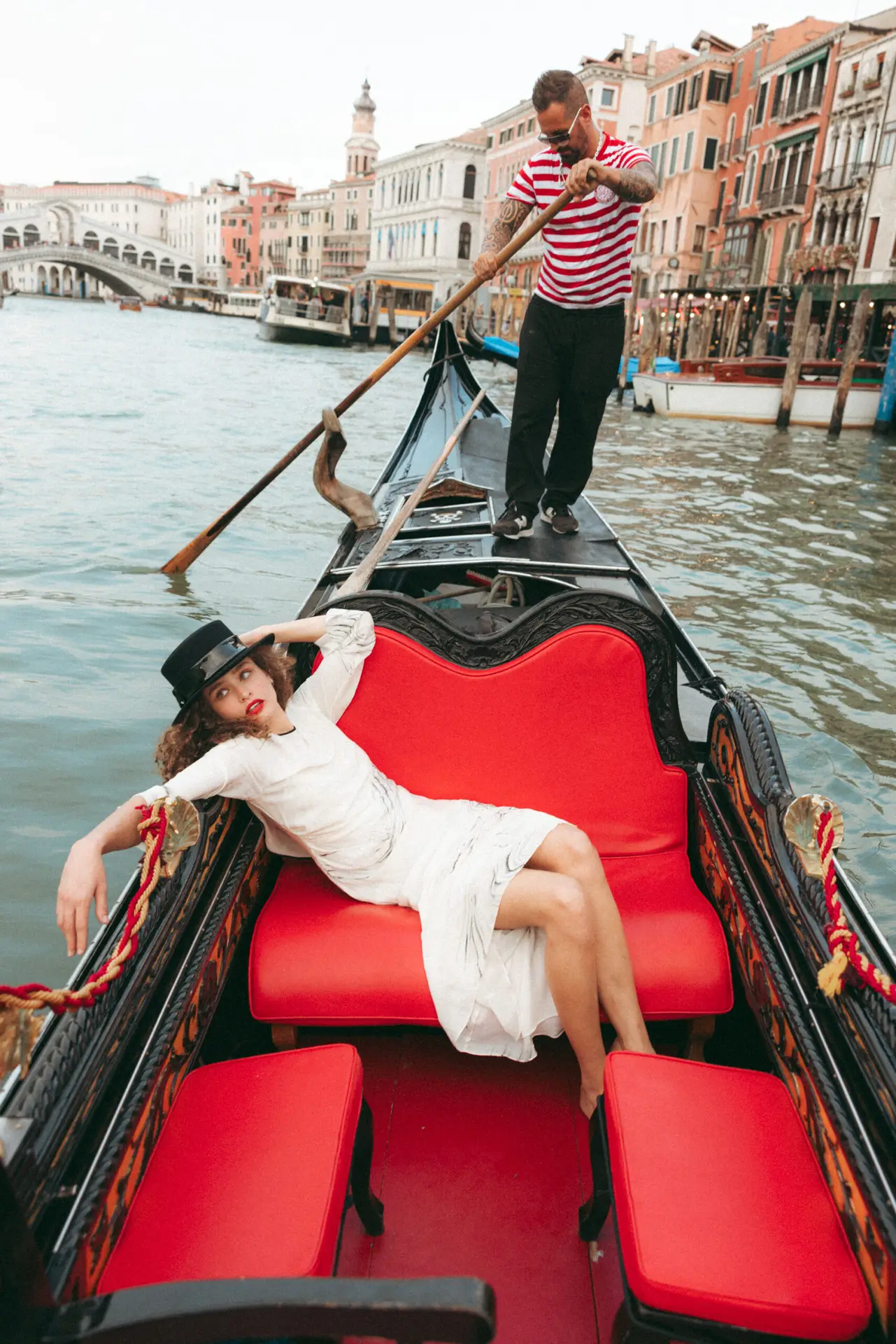 Model in Italy seated on a sandolo Photo taken by Ximena Zermeño Global Luxury Destination Wedding Photographer, ximenazermeno.com