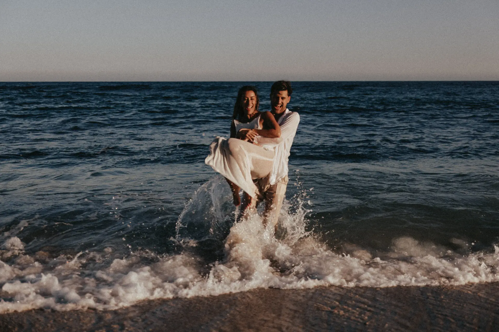 Couple having fun at the beach photo taken by Ximena Zermeño Global Luxury Destination Wedding Photographer, ximenazermeno.com