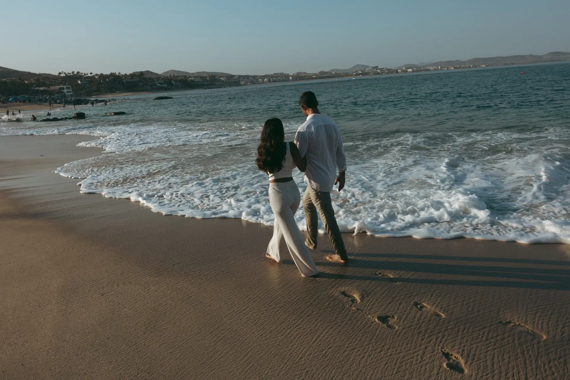 Couple walking at the beach photo taken by Ximena Zermeño Global Luxury Destination Wedding Photographer, ximenazermeno.com