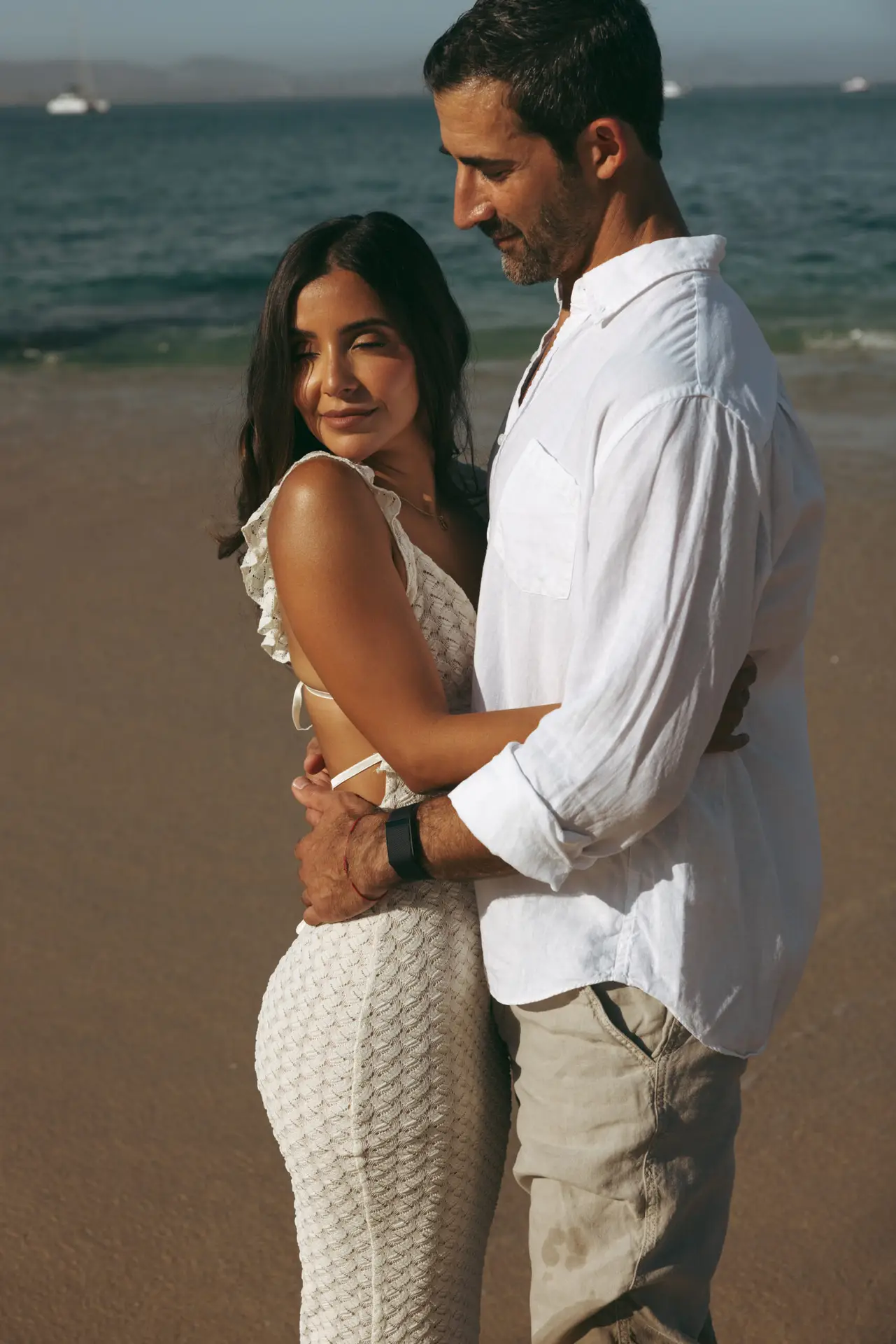 hug by the sea photo taken by Ximena Zermeño Global Luxury Destination Wedding Photographer, ximenazermeno.com