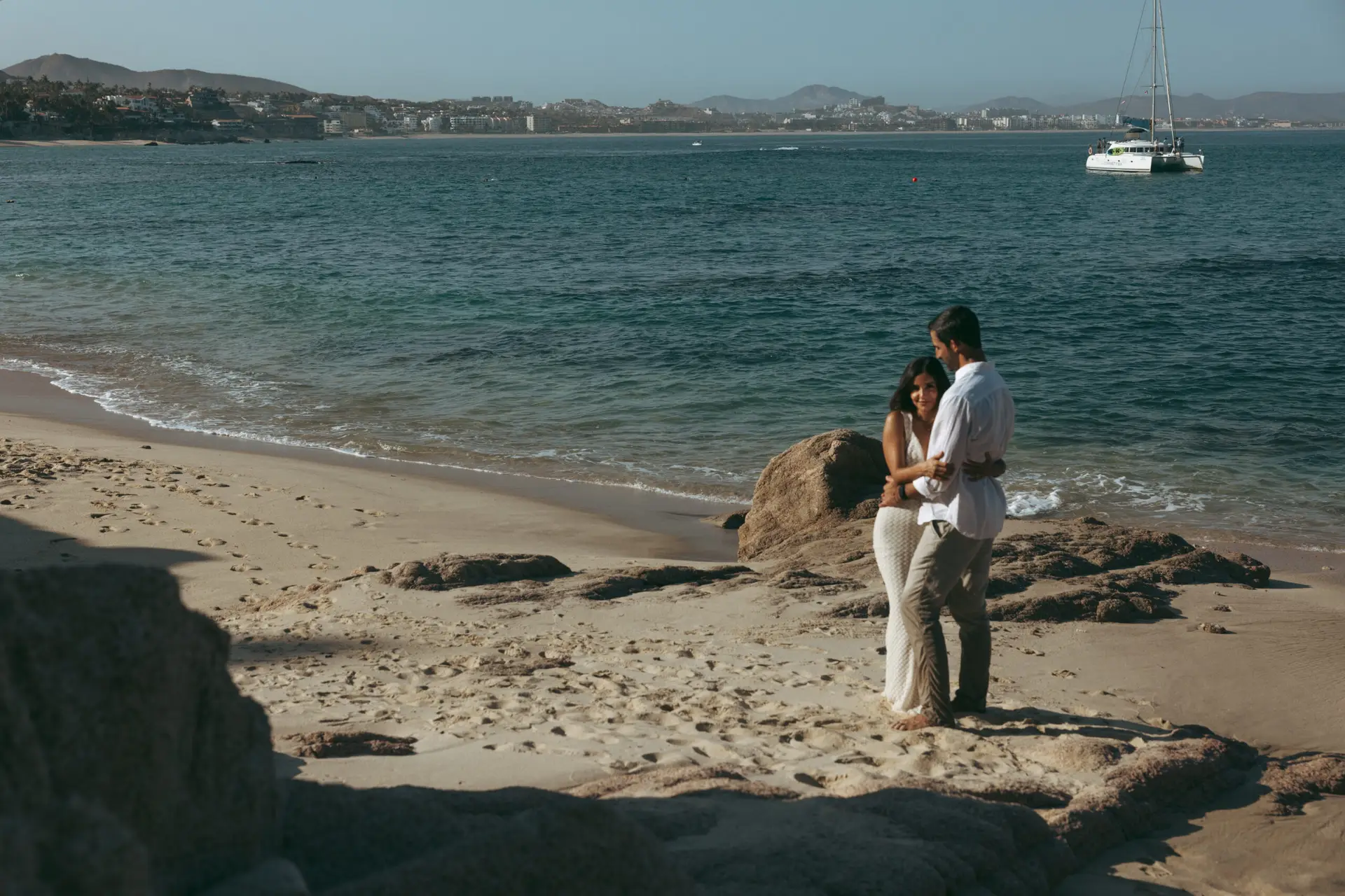 couple hugging at the beach photo taken by Ximena Zermeño Global Luxury Destination Wedding Photographer, ximenazermeno.com