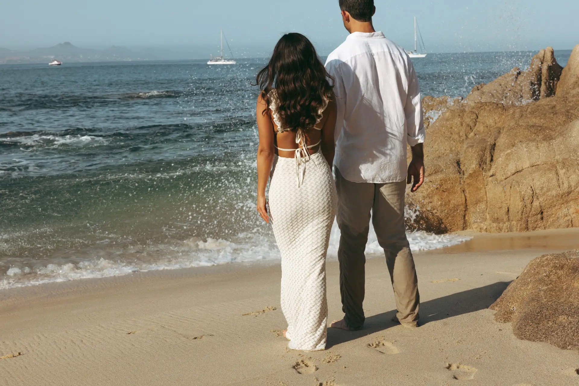 couple walking at the beach photo taken by Ximena Zermeño Global Luxury Destination Wedding Photographer, ximenazermeno.com